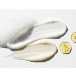 Closeup of several small streaks of midlife skincare products in creams and gel form.