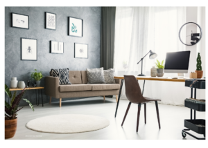 Large, modern, nicely decorated home office with computer desk, computer and sitting couch with decorative pillows.